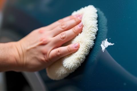Applying wax or sealant to a car's paint for gloss